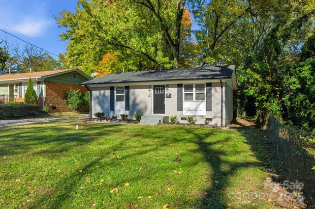 a front view of house with yard and green space