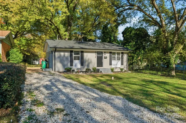 a view of a house with yard and tree s