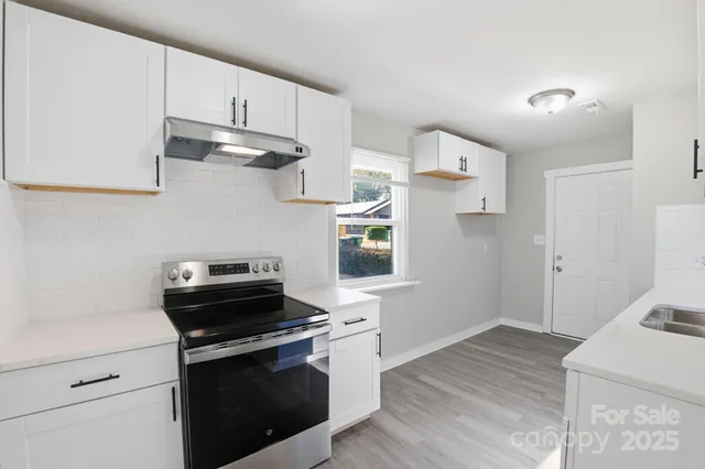 a kitchen with stainless steel appliances a stove a sink and a refrigerator