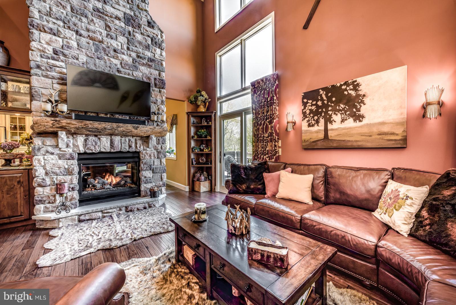 968 Scots Pne Lane Hazleton, PA 18202 - Photo 32 of 95 a living room with furniture a flat screen tv and a fireplace