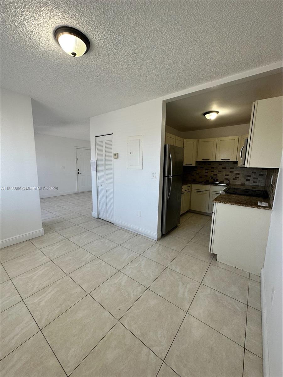 6214 Southwest 131st Court, Unit 201 Miami, FL 33183 - Photo 1 of 18 a kitchen with a cabinets and a stove top oven
