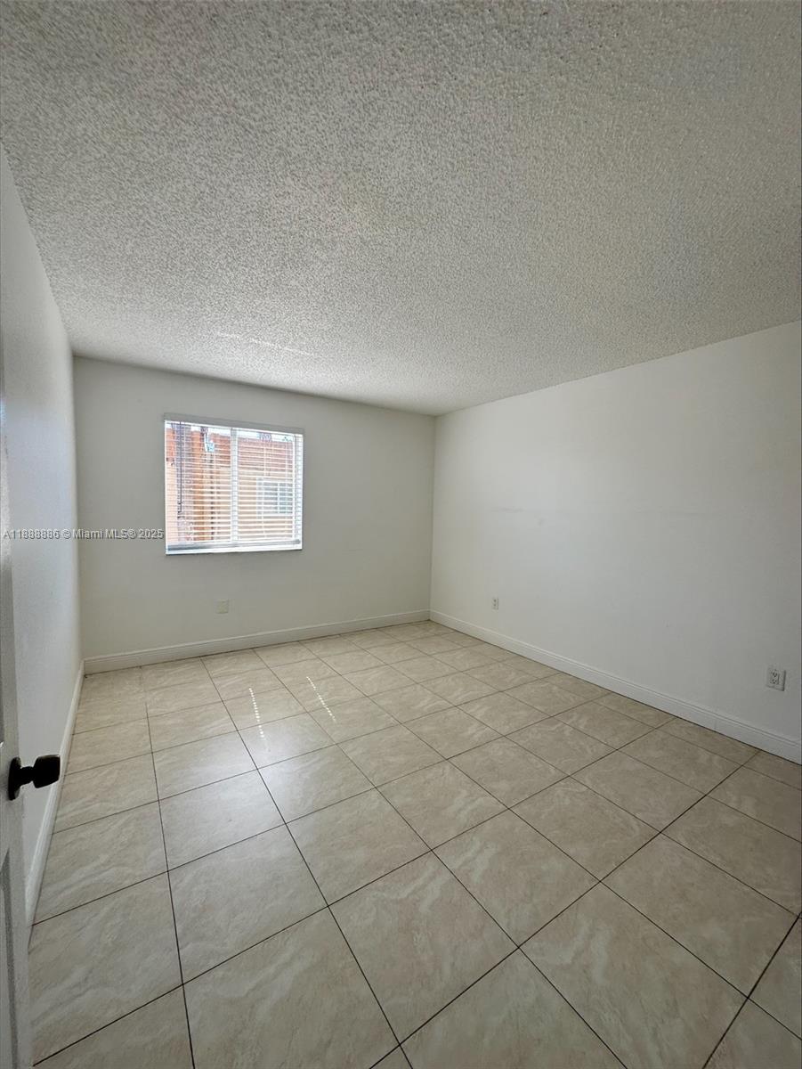 6214 Southwest 131st Court, Unit 201 Miami, FL 33183 - Photo 14 of 18 a view of an empty room with a window