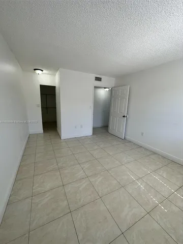 a view of a room with an empty space and empty shelves