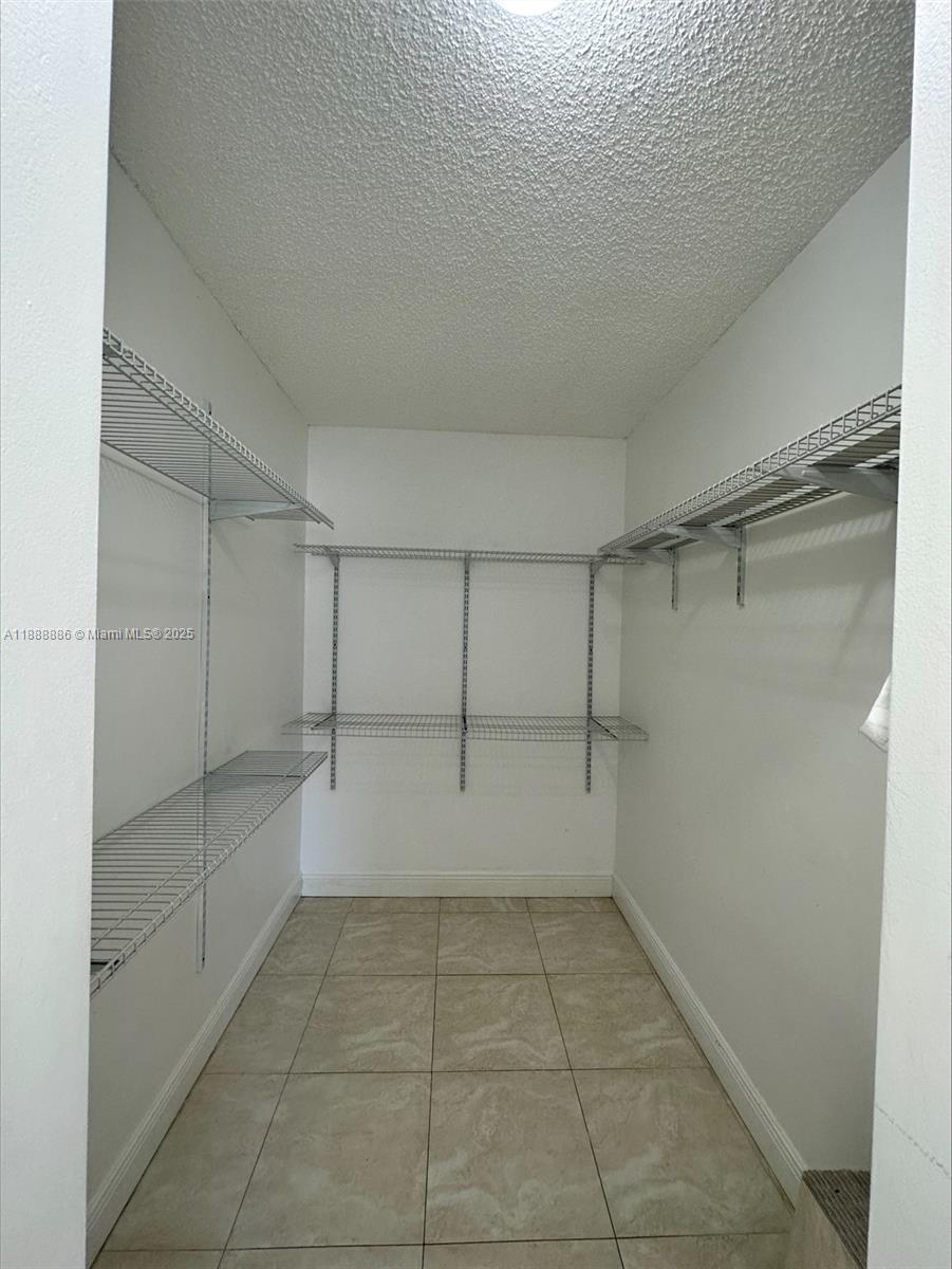 6214 Southwest 131st Court, Unit 201 Miami, FL 33183 - Photo 17 of 18 a view of a room with an empty space and empty shelves