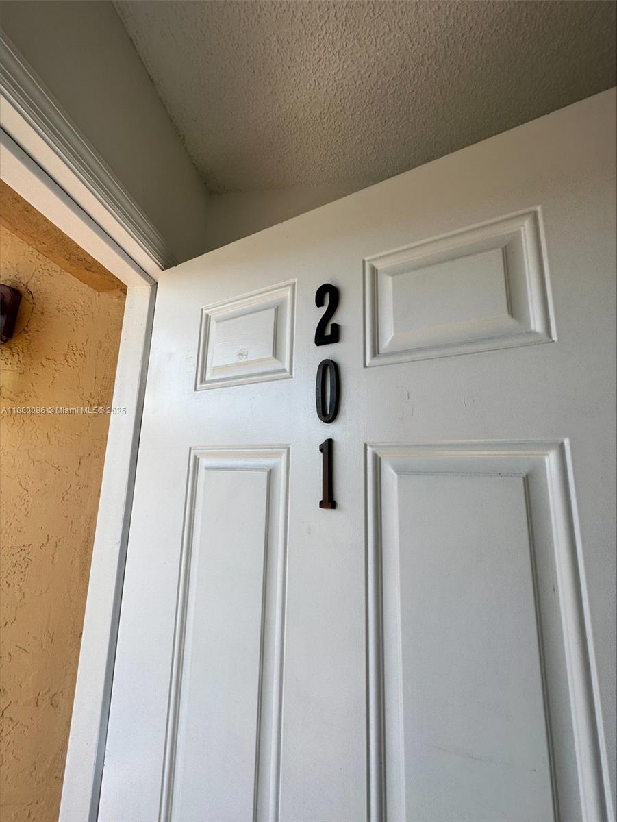 6214 Southwest 131st Court, Unit 201 Miami, FL 33183 - Photo 2 of 18 a view of a hallway with door