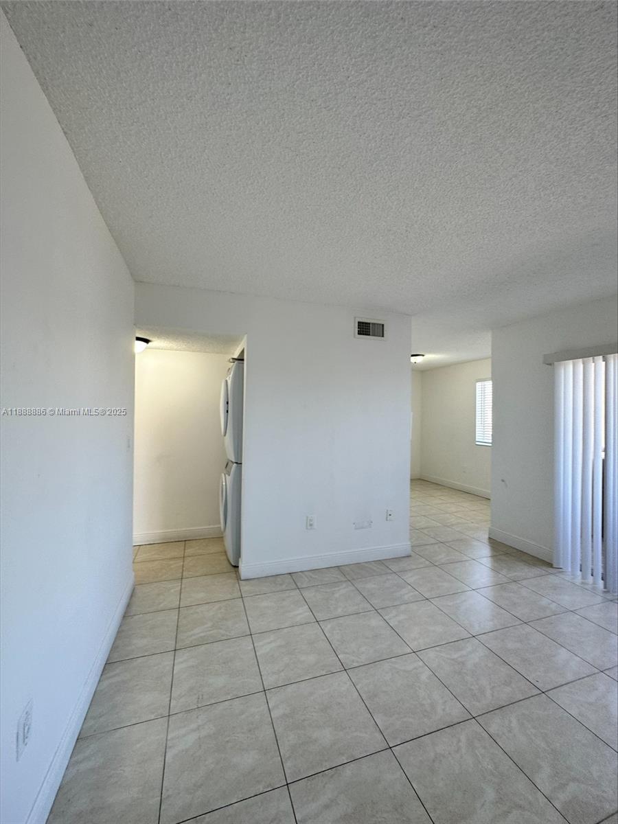 6214 Southwest 131st Court, Unit 201 Miami, FL 33183 - Photo 3 of 18 an empty room with a space and windows