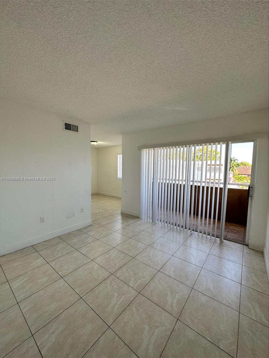 6214 Southwest 131st Court, Unit 201 Miami, FL 33183 - Photo 5 of 18 an empty room with a window