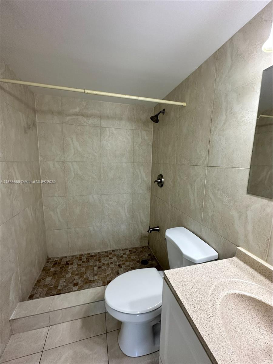 6214 Southwest 131st Court, Unit 201 Miami, FL 33183 - Photo 6 of 18 a bathroom with a sink a toilet and shower