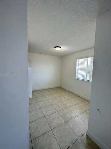 a view of an empty room and a window