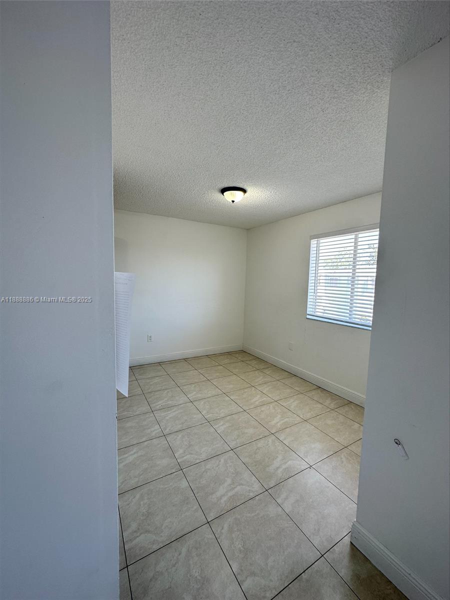 6214 Southwest 131st Court, Unit 201 Miami, FL 33183 - Photo 10 of 18 a view of an empty room and a window