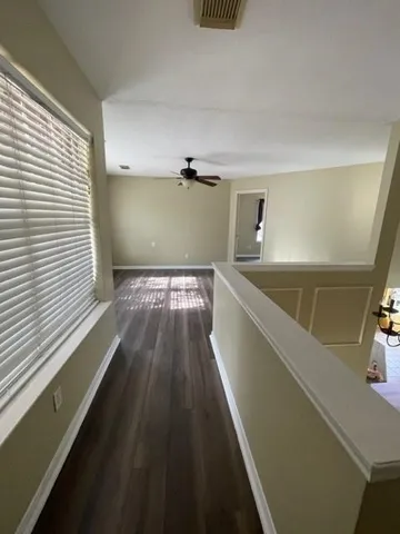 a view of a kitchen with wooden floor and staircase