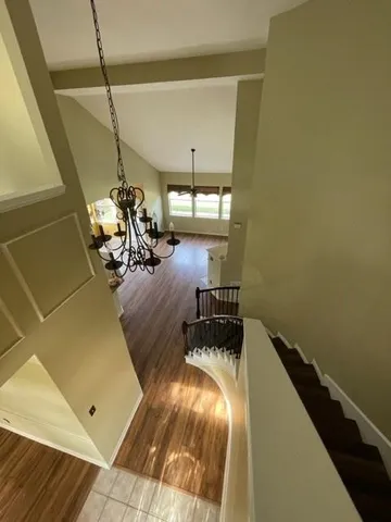 a view of a room with wooden floor