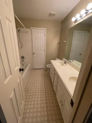 a bathroom with sink a vanity and a mirror