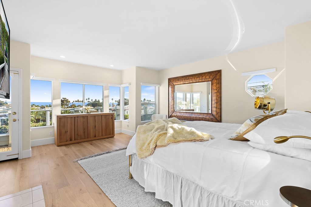 25352 Village Dana Point Dana Point, CA 92629 - Photo 22 of 41 a bedroom with a bed and wooden floor