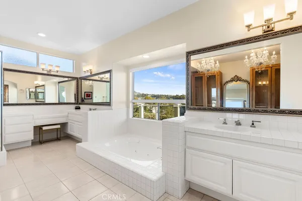 a bathroom with a bathtub sink and mirror
