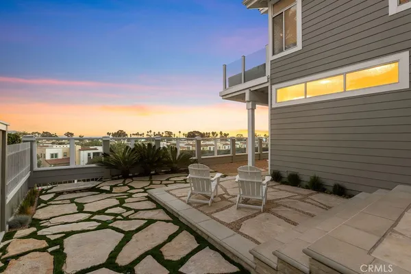a view of a terrace with furniture and city view