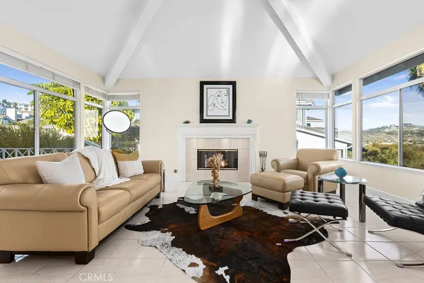 a living room with furniture fireplace and a large window