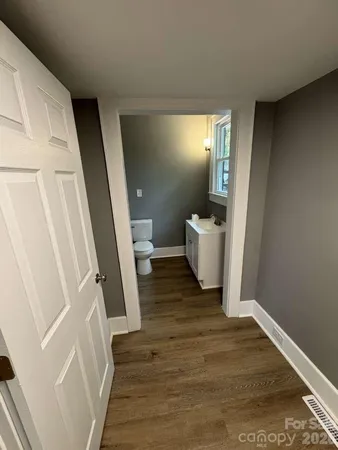 a view of a room with wooden floor and chair
