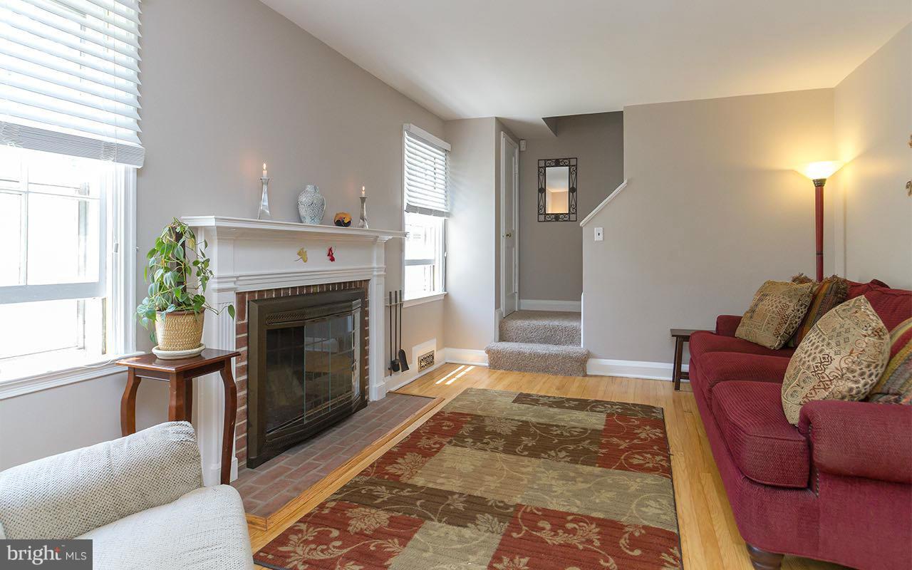 810 Olmstead Road Pikesville, MD 21208 - Photo 12 of 30 a living room with furniture and a fireplace