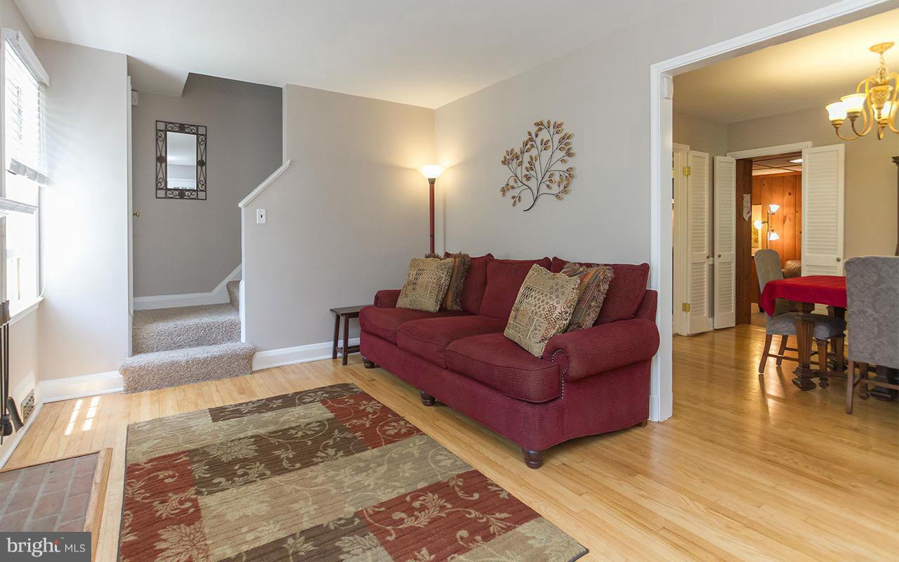 810 Olmstead Road Pikesville, MD 21208 - Photo 14 of 30 a living room with furniture and wooden floor