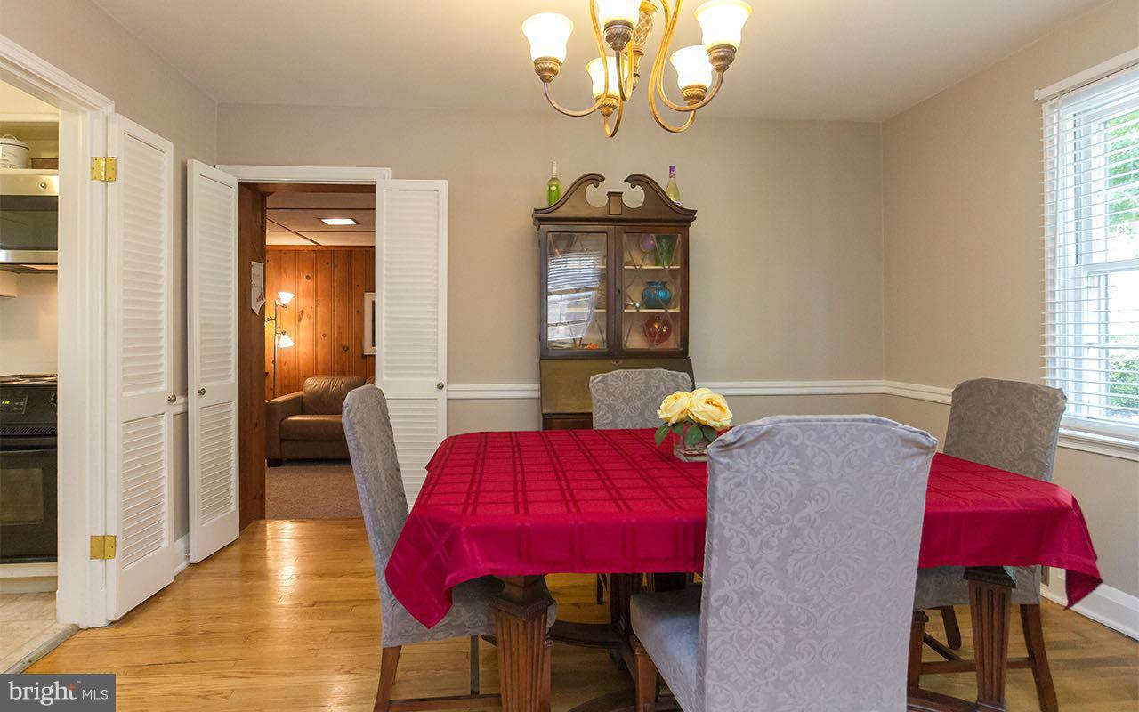 810 Olmstead Road Pikesville, MD 21208 - Photo 17 of 30 a view of a dining room with furniture and chandelier