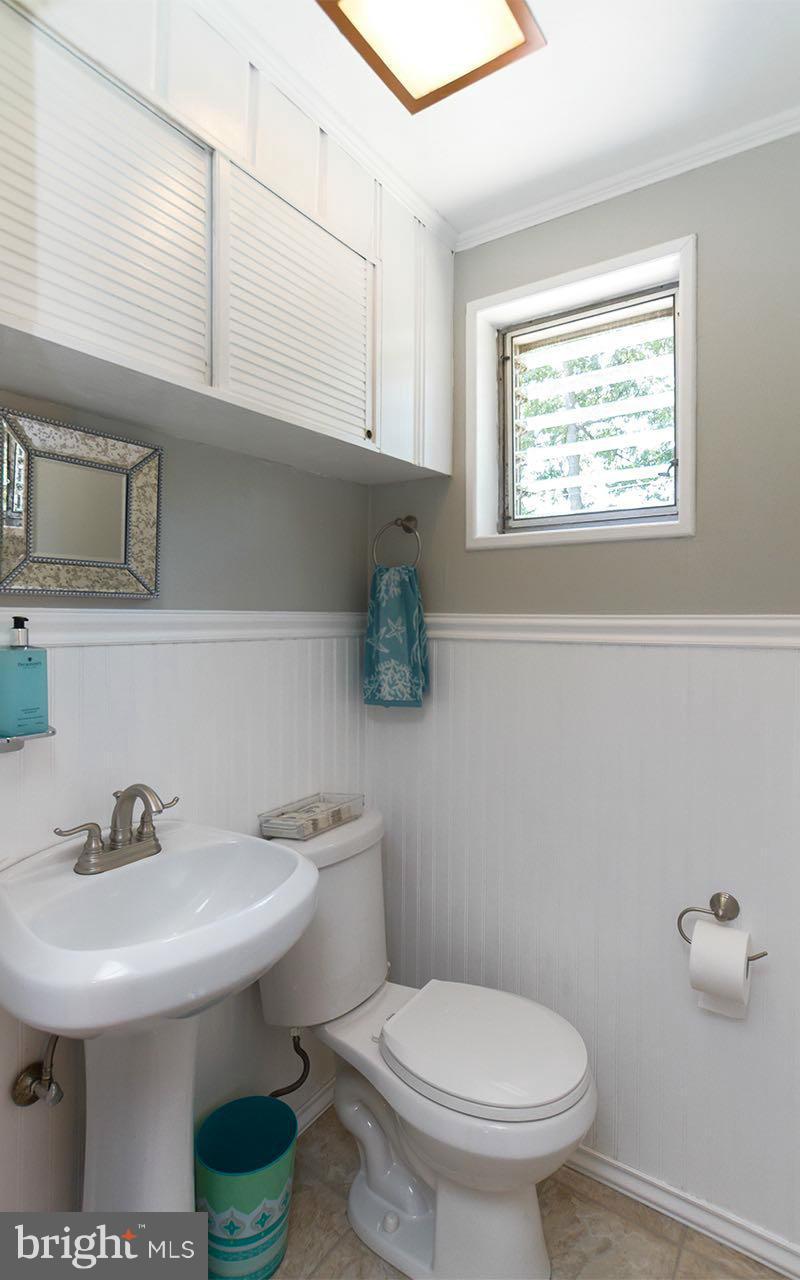 810 Olmstead Road Pikesville, MD 21208 - Photo 19 of 30 a bathroom with a sink a toilet and mirror