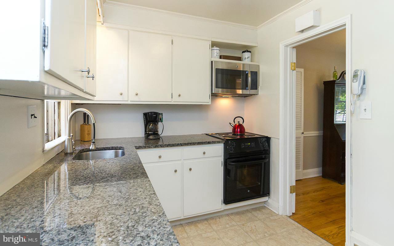 810 Olmstead Road Pikesville, MD 21208 - Photo 3 of 30 a kitchen with stainless steel appliances granite countertop a stove sink and cabinets