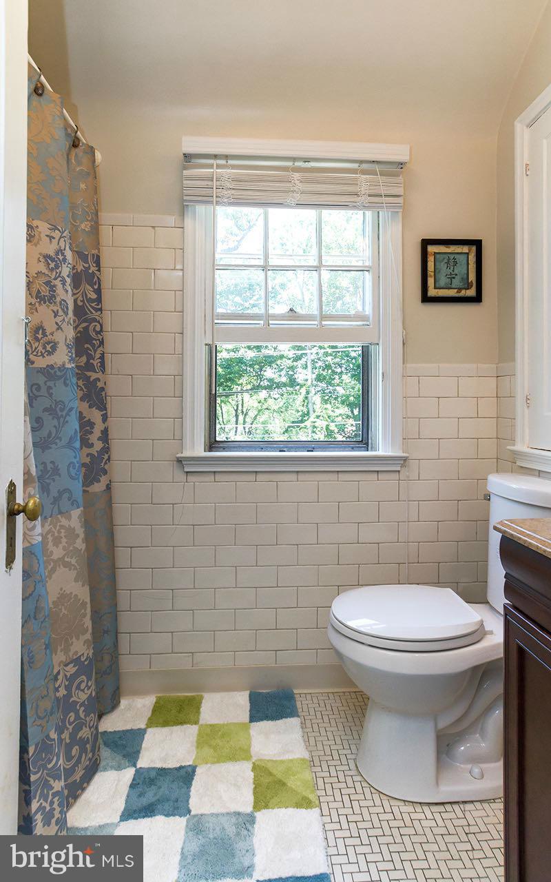 810 Olmstead Road Pikesville, MD 21208 - Photo 22 of 30 a bathroom with a sink a toilet and a window