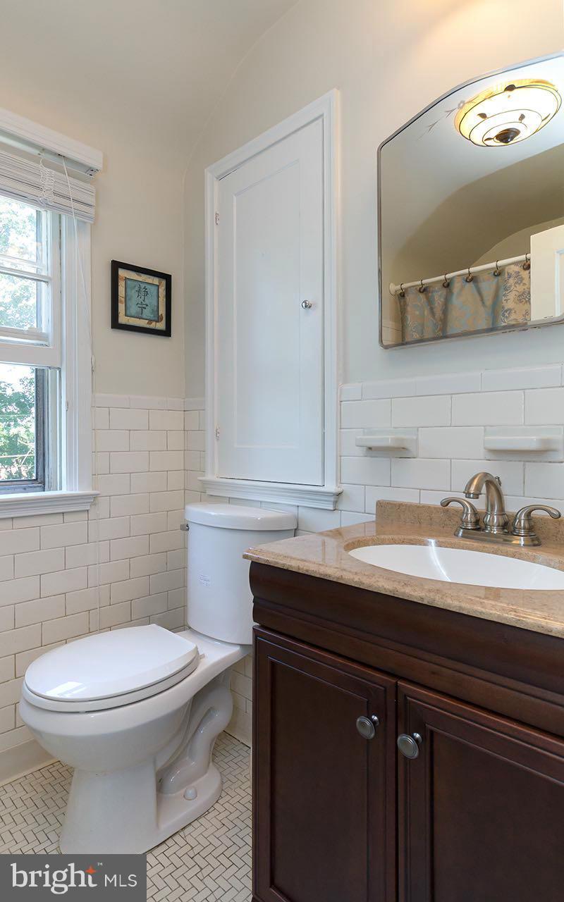 810 Olmstead Road Pikesville, MD 21208 - Photo 23 of 30 a bathroom with a toilet a sink and mirror