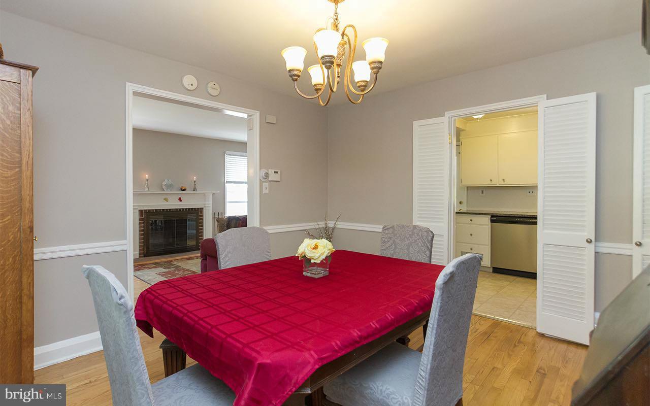 810 Olmstead Road Pikesville, MD 21208 - Photo 8 of 30 a view of a dining room with furniture and a chandelier