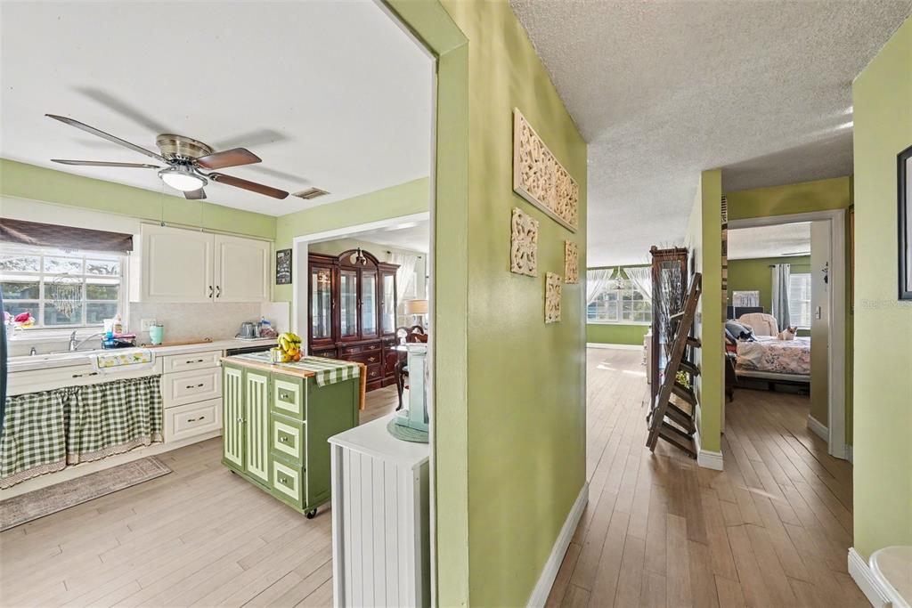 701 Poinsettia Road, Unit 240 Belleair, FL 33756 - Photo 14 of 30 a kitchen with cabinets a counter top space a sink and wooden floor