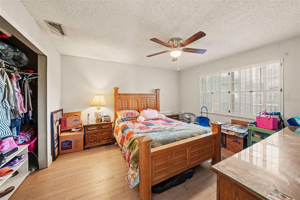 701 Poinsettia Road, Unit 240 Belleair, FL 33756 - Photo 19 of 30 a bedroom with bed and a chandelier