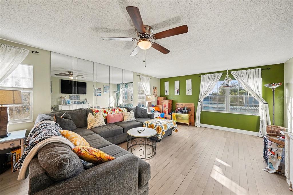 701 Poinsettia Road, Unit 240 Belleair, FL 33756 - Photo 2 of 30 a living room with furniture and a large window