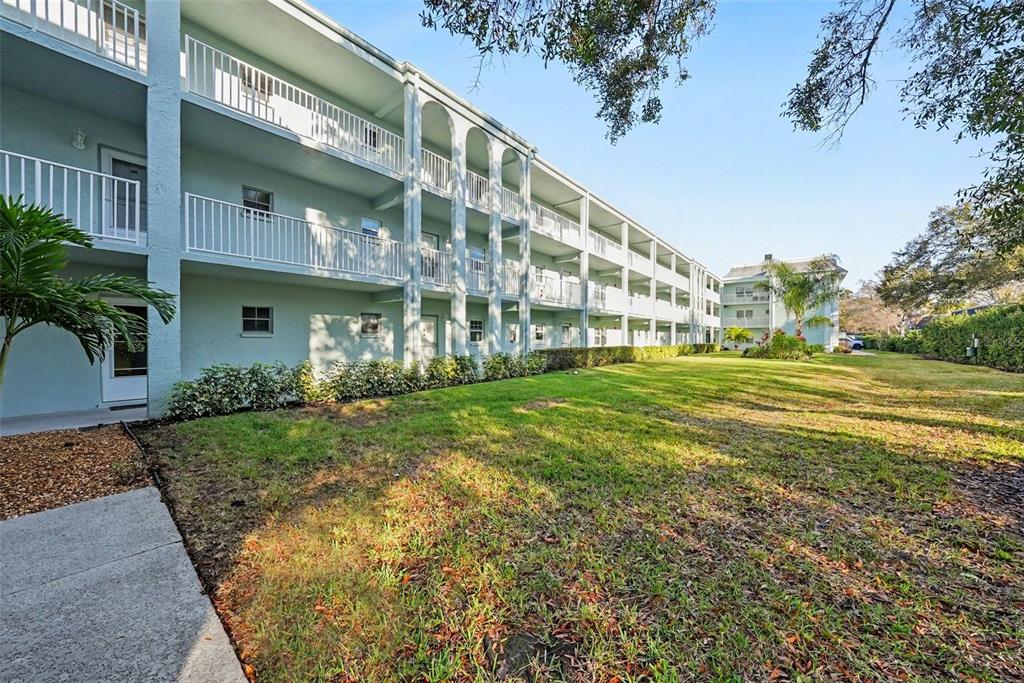 701 Poinsettia Road, Unit 240 Belleair, FL 33756 - Photo 21 of 30 a view of a building with a yard