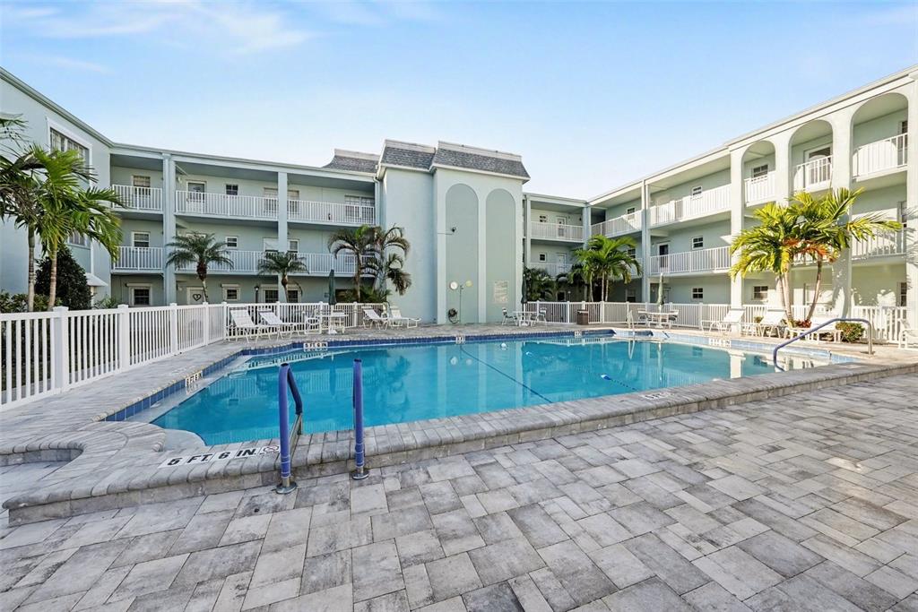 701 Poinsettia Road, Unit 240 Belleair, FL 33756 - Photo 28 of 30 a swimming pool with outdoor seating