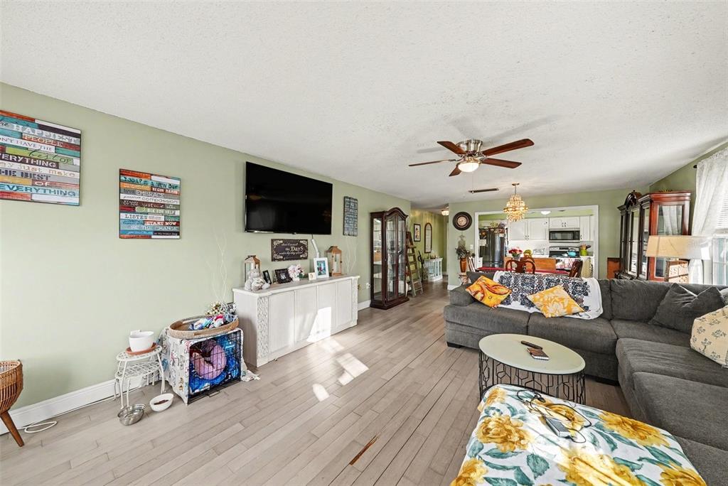 701 Poinsettia Road, Unit 240 Belleair, FL 33756 - Photo 6 of 30 a living room with furniture and a flat screen tv