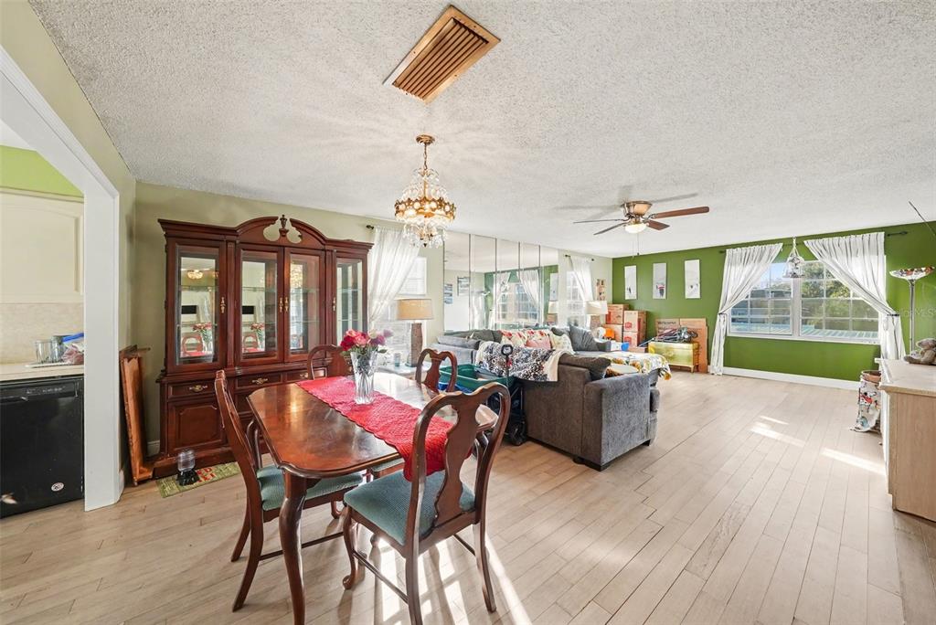 701 Poinsettia Road, Unit 240 Belleair, FL 33756 - Photo 8 of 30 a view of a dining room with furniture large windows and wooden floor