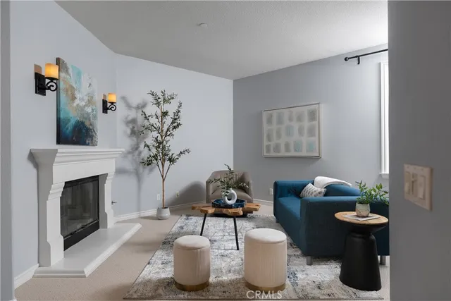 a living room with furniture a potted plant and a fireplace