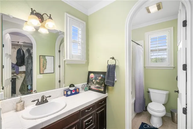 a bathroom with a tub a sink and mirror