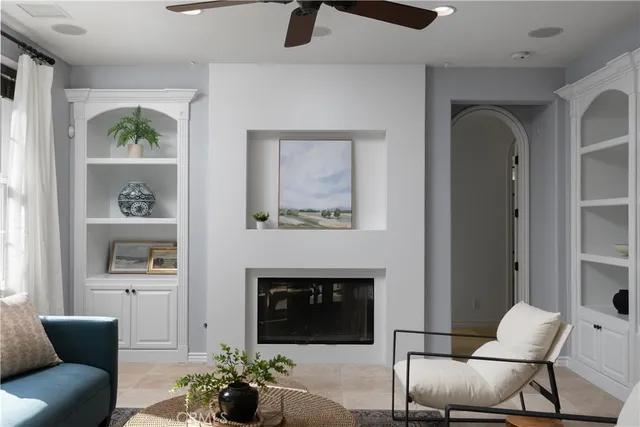 a kitchen with stainless steel appliances kitchen island granite countertop a stove a sink a refrigerator and white cabinets with wooden floor