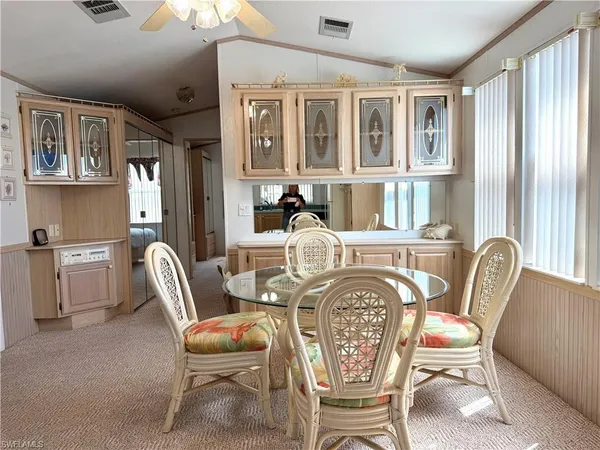 a view of a dining room with furniture large window and wooden floor