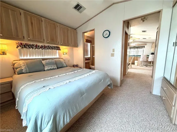 a bedroom with a bed and a cabinets