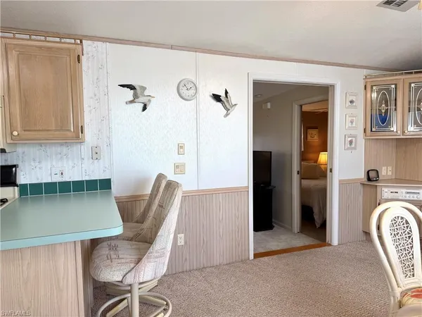 a view of kitchen with granite countertop cabinets table and chairs