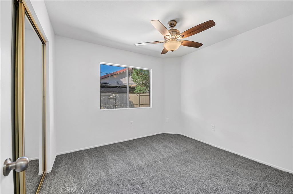27042 Rangewood Street Menifee, CA 92586 - Photo 18 of 22 an empty room with window and ceiling fan