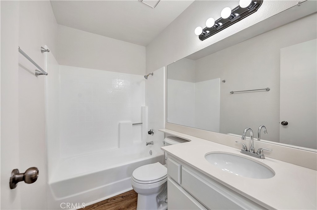 27042 Rangewood Street Menifee, CA 92586 - Photo 19 of 22 a bathroom with a sink a toilet and shower