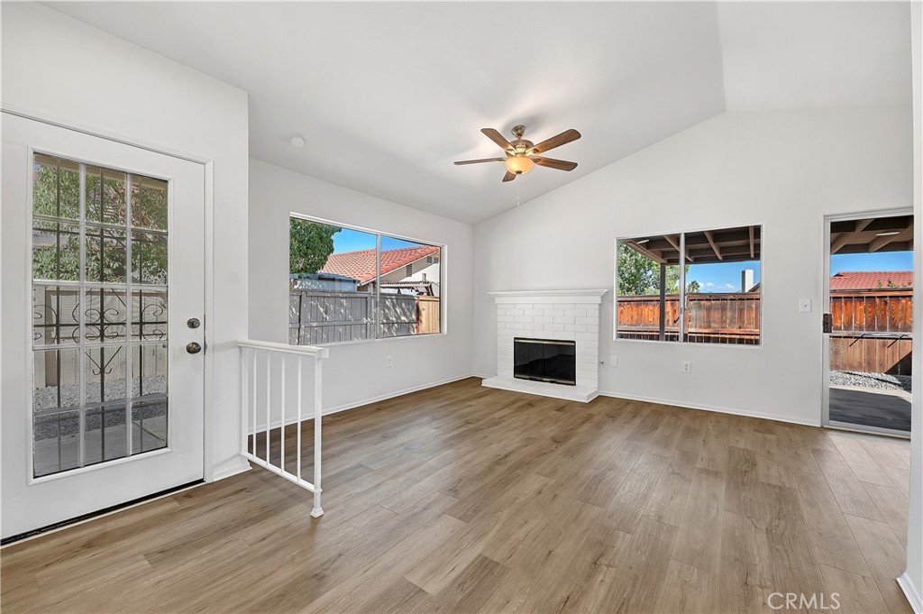27042 Rangewood Street Menifee, CA 92586 - Photo 9 of 22 wooden floor in an empty room with a window