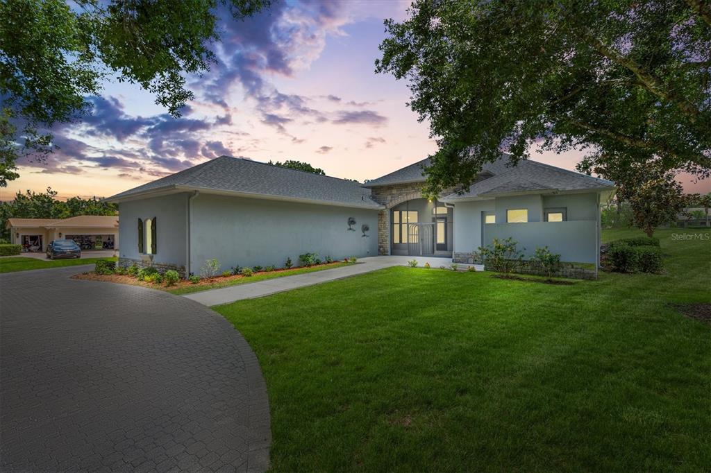 a front view of a house with a garden