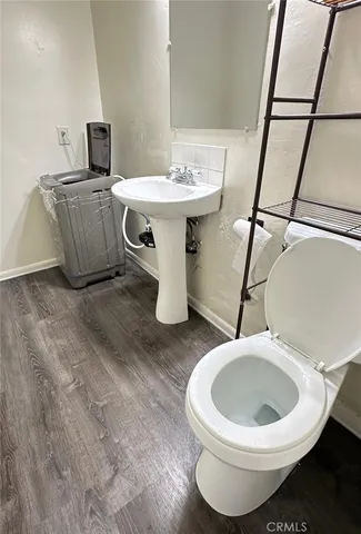 a view of a hallway with wooden floor and stairs