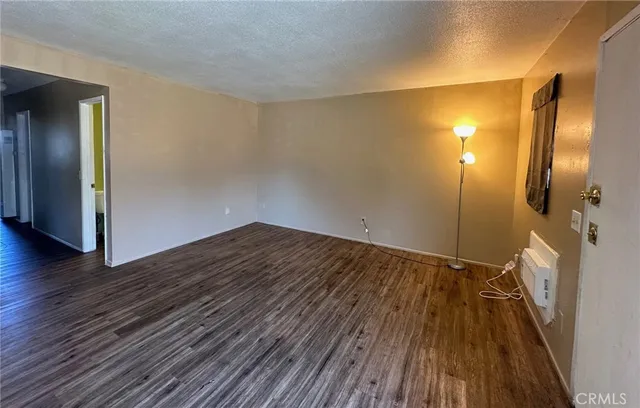 a kitchen with granite countertop a sink stove and cabinets