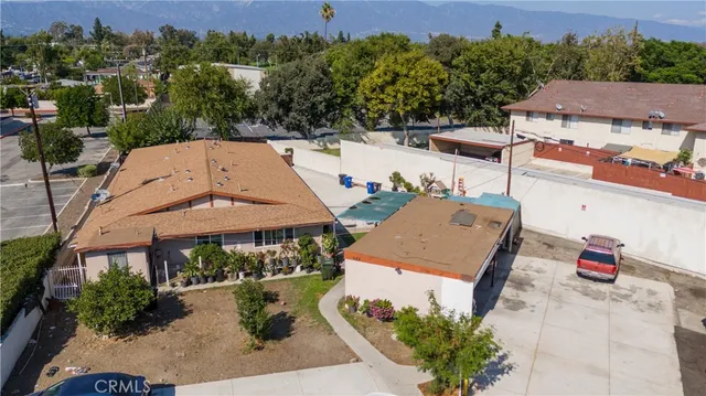 an aerial view of a house with garden space and street view